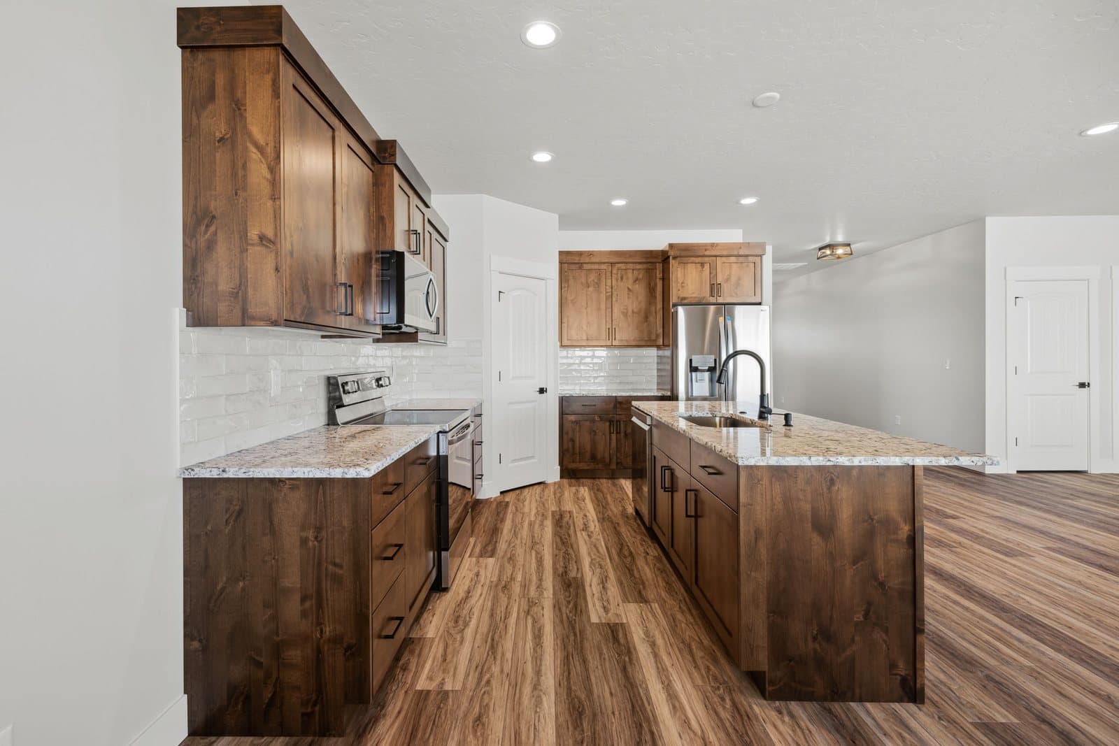 Kitchen island and stainless appliances in an Old's Ferry home, Weiser