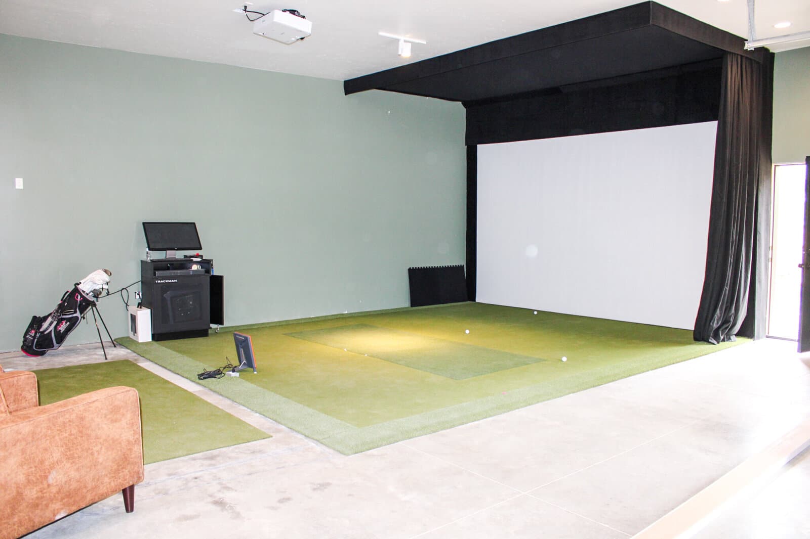Indoor golf simulator room in a custom home