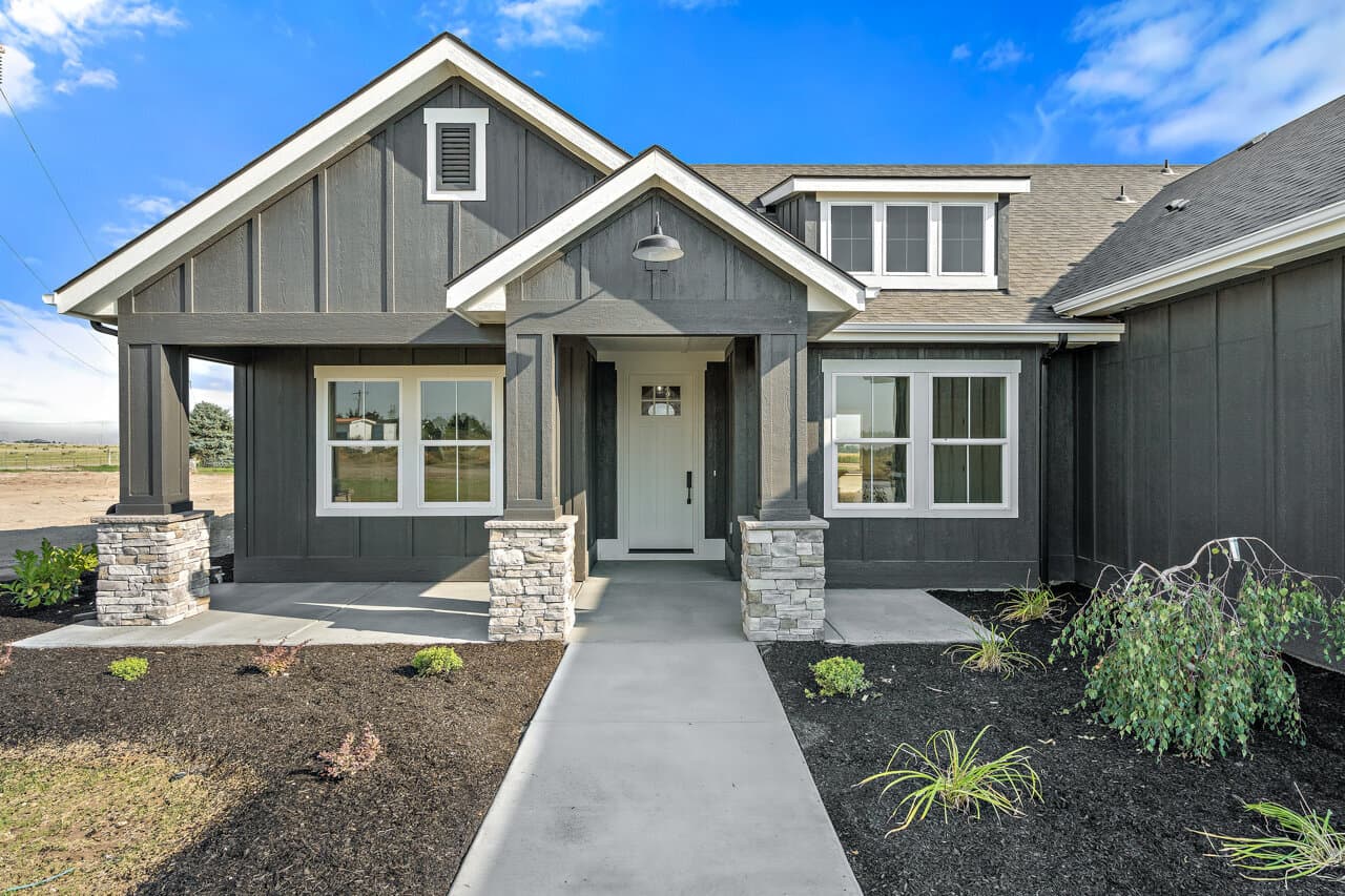Front porch and entry of the custom home at 16966 Long Meadow Dr, Caldwell