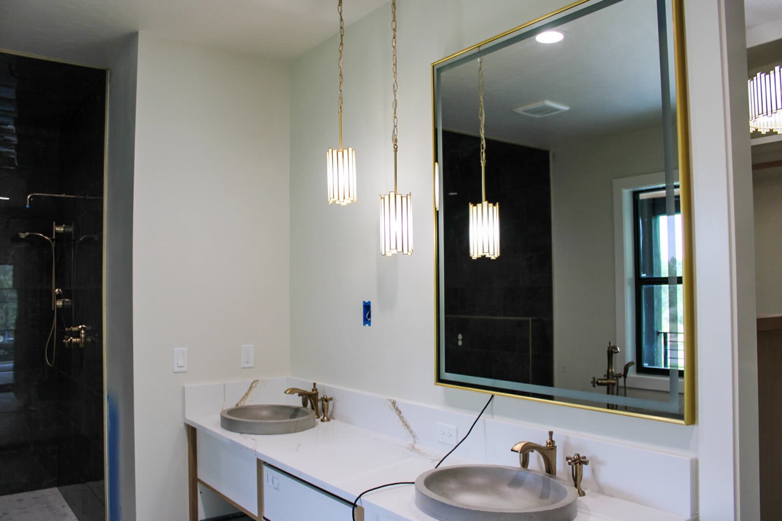 Bathroom vanity with pendant lights in a custom home