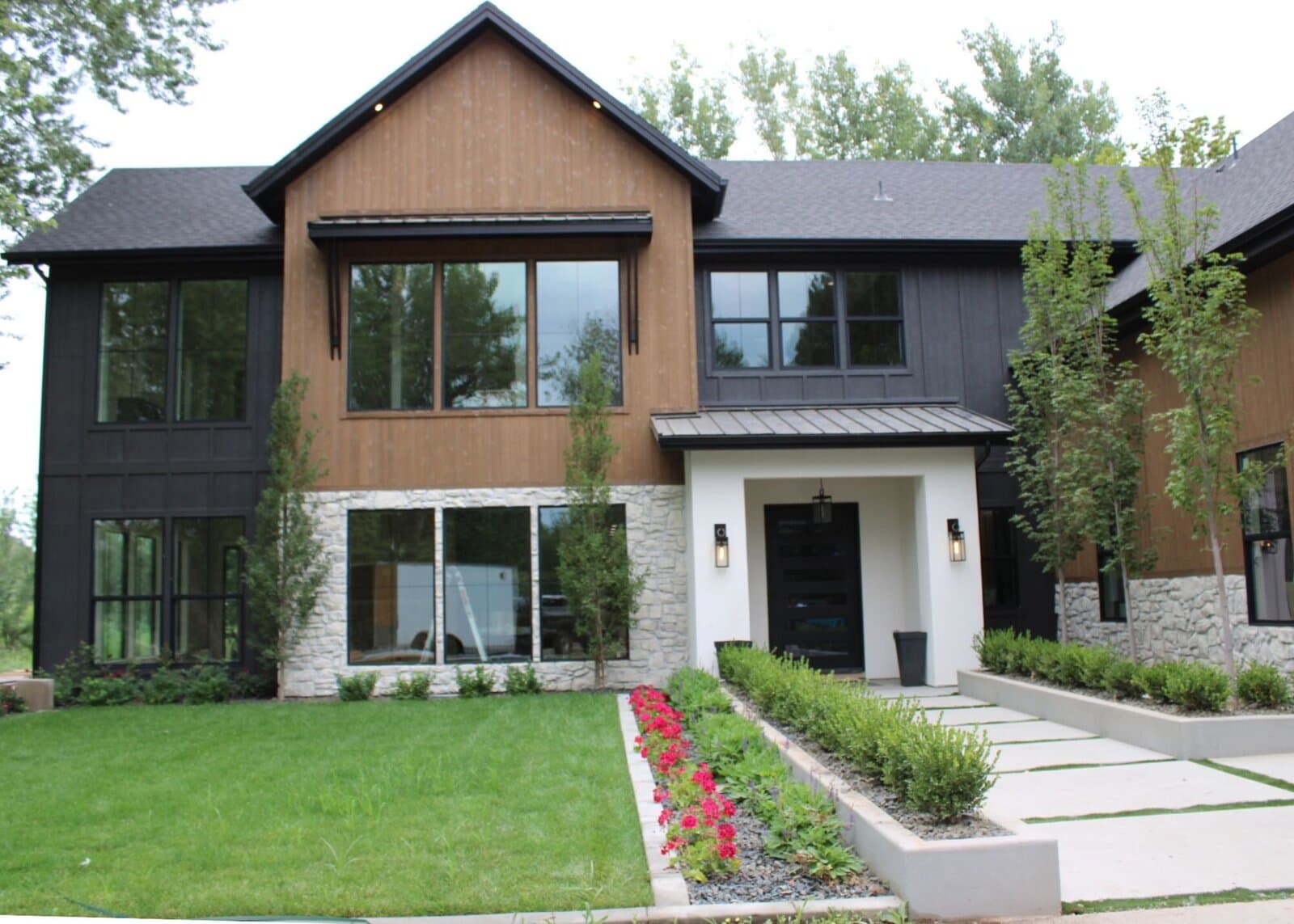 Two-story custom home with wood and black siding built by TKO Homes